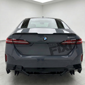 Rear view of a dark gray BMW S300i sedan in a clean indoor showroom or studio setting, with a large semi-transparent 'Auto Fix' watermark overlay on the trunk.